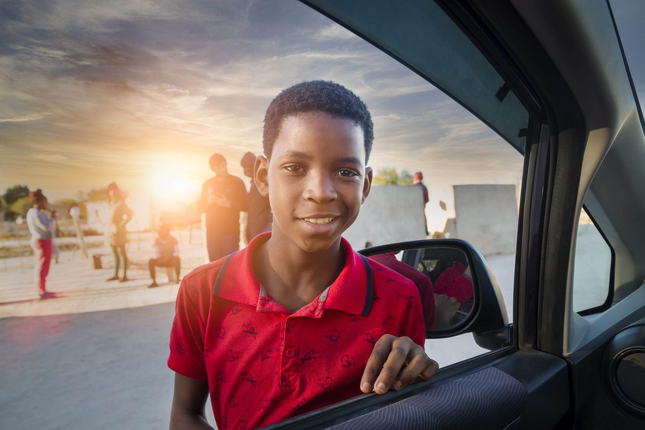 portrait of an African child  looking at the camera through the car window